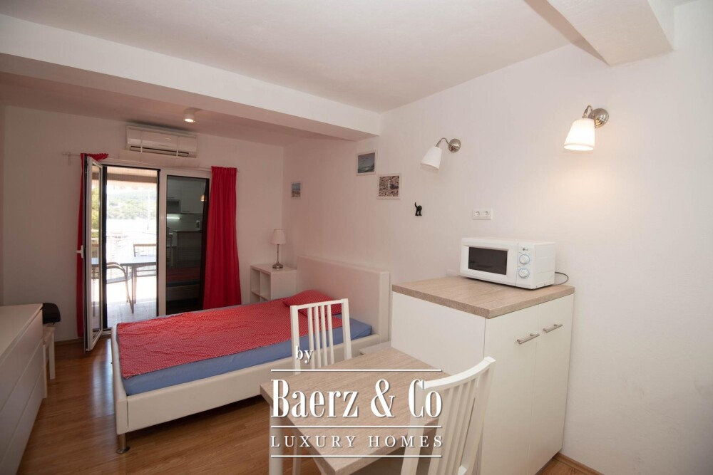 Tisno, exclusive seafront apartment house with panoramic sea views and a boat image